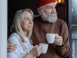 A senior couple embraces while enjoying coffee, symbolizing love and companionship.